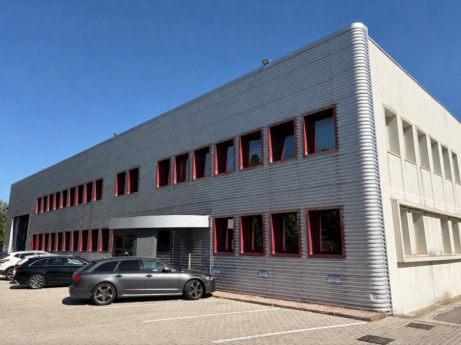 Sede STC Group: facciata dell'edificio con rivestimento in alluminio e finestre bordate di rosso